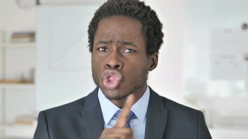 Young Adult Man Gesturing in Office Setting