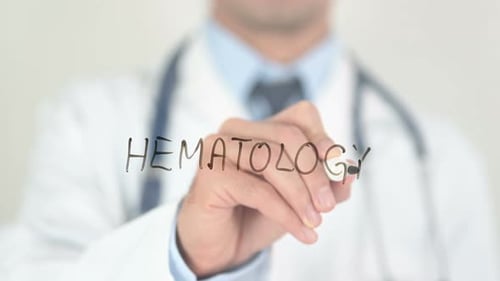 Doctor Writing Hematology on Clear Surface
