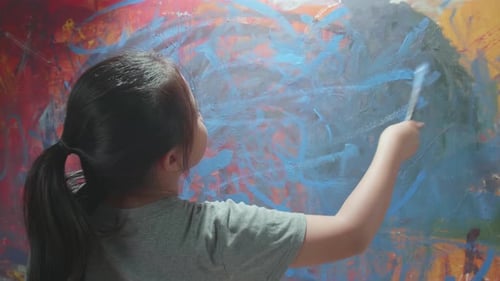 Girl Creates Colorful Abstract Painting at Home