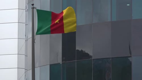 Realistic Cameroon Flag Waving on Modern Building Exterior