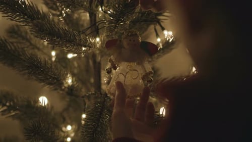 Decorating Christmas Tree with Angel Ornament at Home