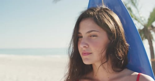 Caucasian woman ready to go surf