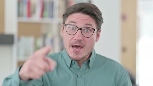 Man Talking and Gesturing Indoors