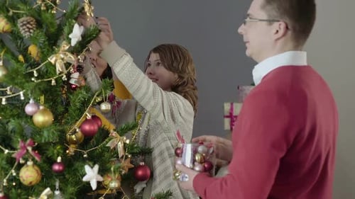 Family Decorating Christmas Tree Together Indoors