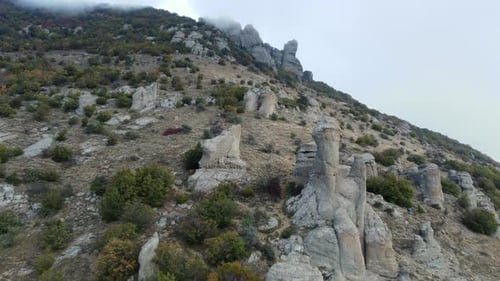 Mountains with Rocky Sculptures That are Getting Covered By Clouds