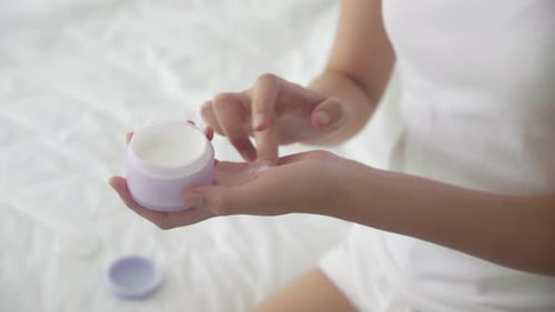 Woman Applies Skin Cream to Her Hand