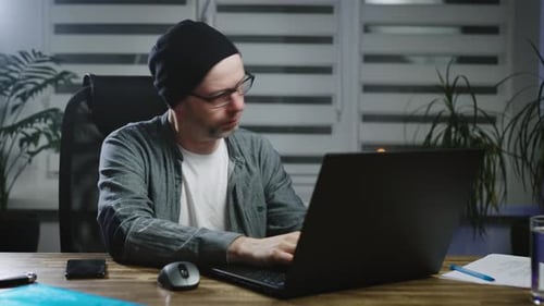 Man Works Late, Closes Laptop, Leaves the Room