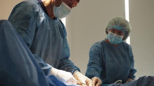Surgeons Performing Operation in Hospital Operating Room