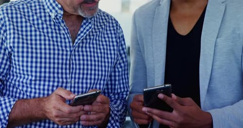 Men looking at smartphone in the workplace