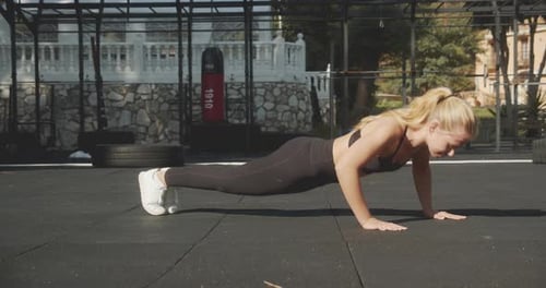 Athlete Performing Press Ups In Outdoor Gym