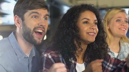 Young Friends Extremely Glad About Favorite Team Victory, Watching Game in Bar