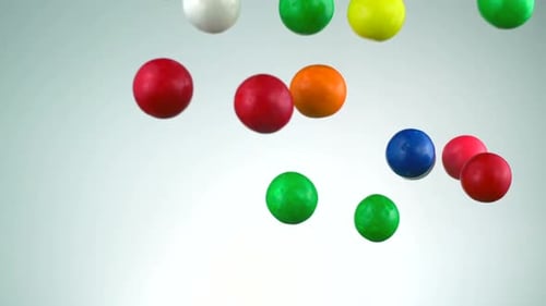 Slo-motion bubble gum balls in the air