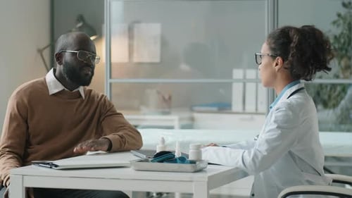 Patient Talking With Doctor in Medical Office