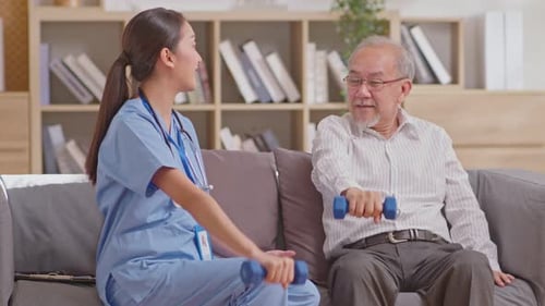 Woman Coaching Senior Man Lifting Weights at Home