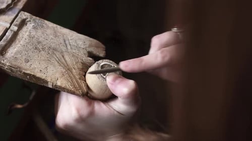 Crop woman working on creation of jewelry