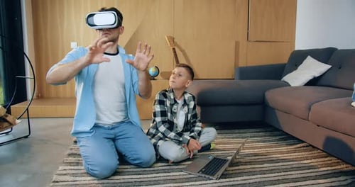 Father and Son Enjoying Virtual Reality at Home