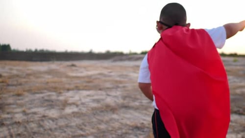 superhero boy running on the field