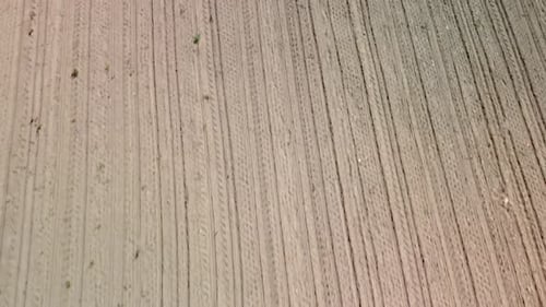 Ploughed dry field pattern drone view perspective in 4k.