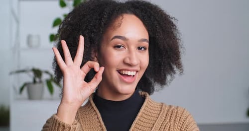 Woman Smiling and Gesturing Okay Sign