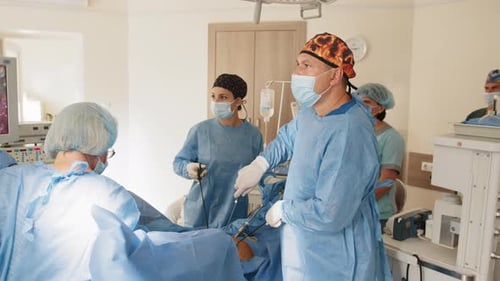 Surgeons Team Performing Operation in Hospital Operating Theater Surgeon