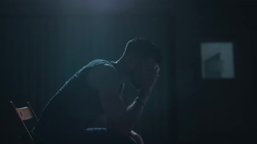 Man alone in a dark room