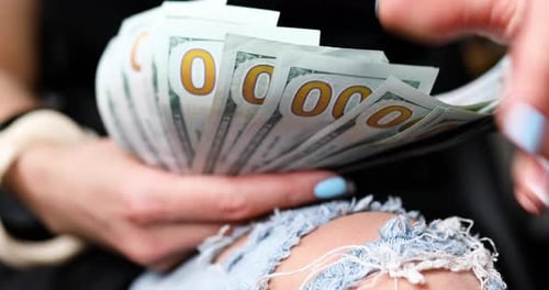 Hands Counting Stack of US Hundred Dollar Bills