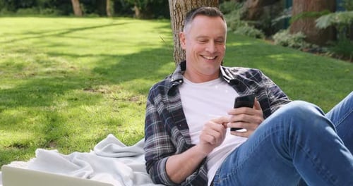 Man using mobile phone in the garden 4k