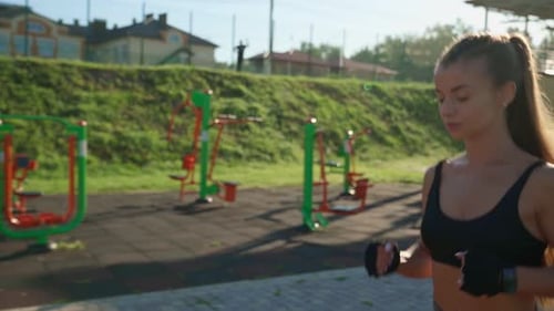 Woman Running at Stadium in Morning