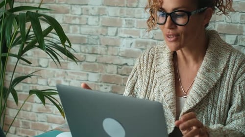 Woman Using Laptop for Video Conference at Home
