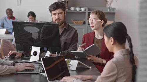 Team Works Together on Computers at Modern Office