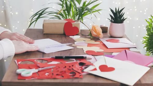 Woman Making Handmade Valentine's Day Card at Home