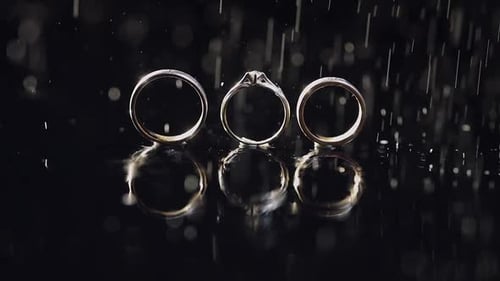 Wedding Rings Sparkling with Falling Water Drops