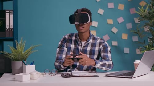 Man Using Virtual Reality Headset at Desk