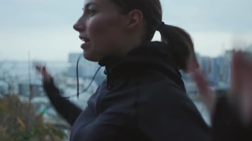 Woman Jumping Jacks Exercising in City Park