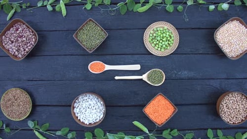 Bowls of Beans and Lentils on Dark Wooden Table