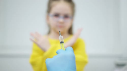 Child Refusing Vaccine from Medical Professional