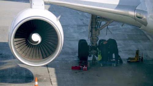 Video of Two Mechanics Reapiring Airplane Before Flight. Aircraft Maintenance on Ground at Airport