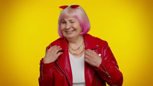 Smiling Senior Woman Winking in Red Leather Jacket