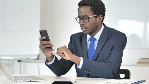 Young Adult Using Mobile Phone in Office