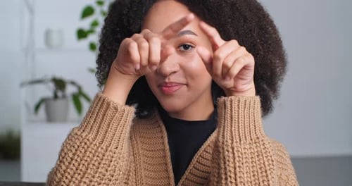 Young Woman Makes Heart Shape With Hands