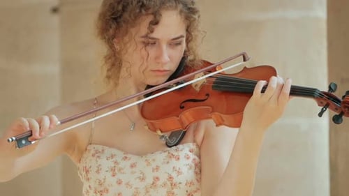 Woman Plays Violin Outdoors in City Close Up