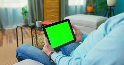 Close Up of Digital Tablet with Blank Green Mock Up Screen Display Hold By Old