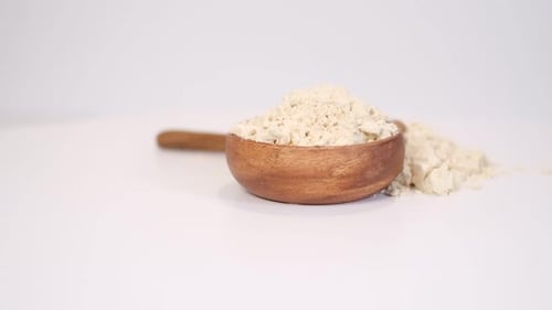 Wooden Bowl and Spoon with Flour Close Up