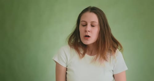 Angry Tired Young Woman Breathes Heavily Posing for Camera