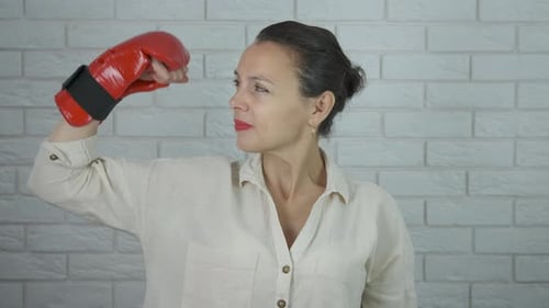 Woman Poses in Boxing Gloves Indoors