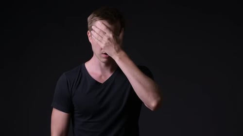 Young Handsome Man Against Black Background