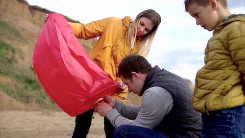Family Launching a Sky Lantern in Nature