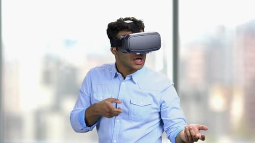 Young Adult Using Virtual Reality Headset Indoors