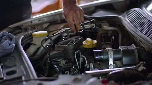 Mechanic Working on Car Engine Repair