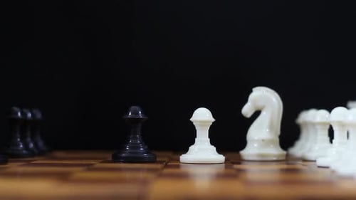 Hand Moves Chess Pieces on Chess Board